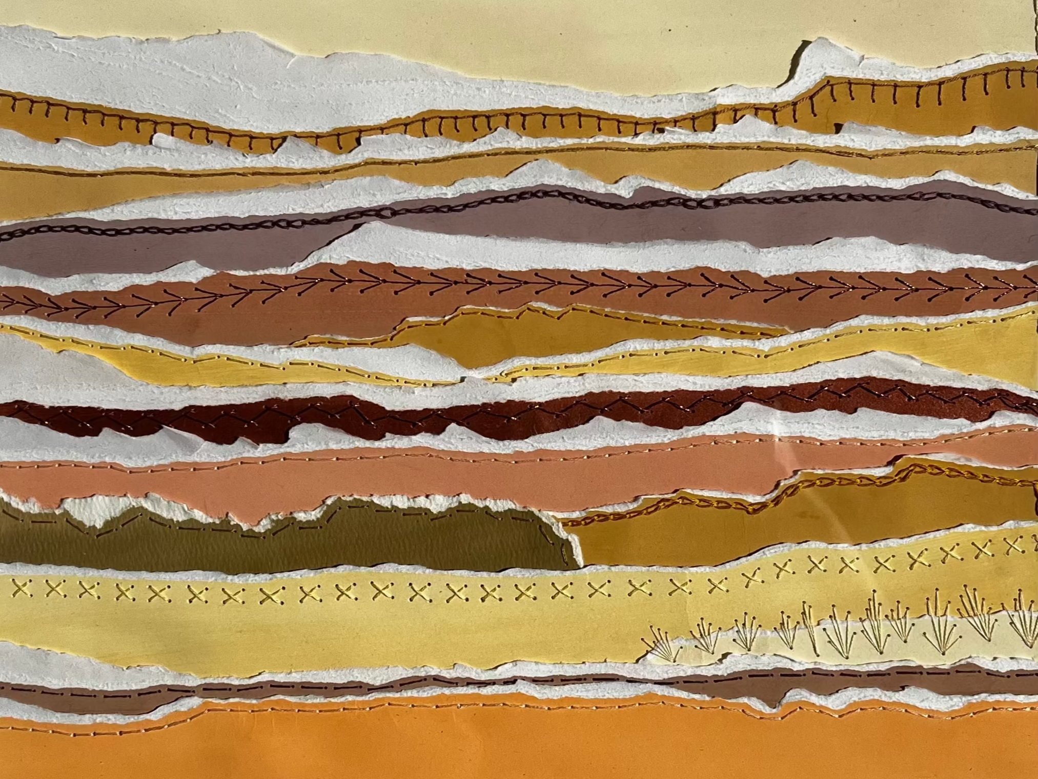 Long strips of gouache painted paper, torn, and hand sewn using a variety of hand embroidery stitches, in a 16"x20" white frame, matted to 11"x14" to display this mixed media piece. 